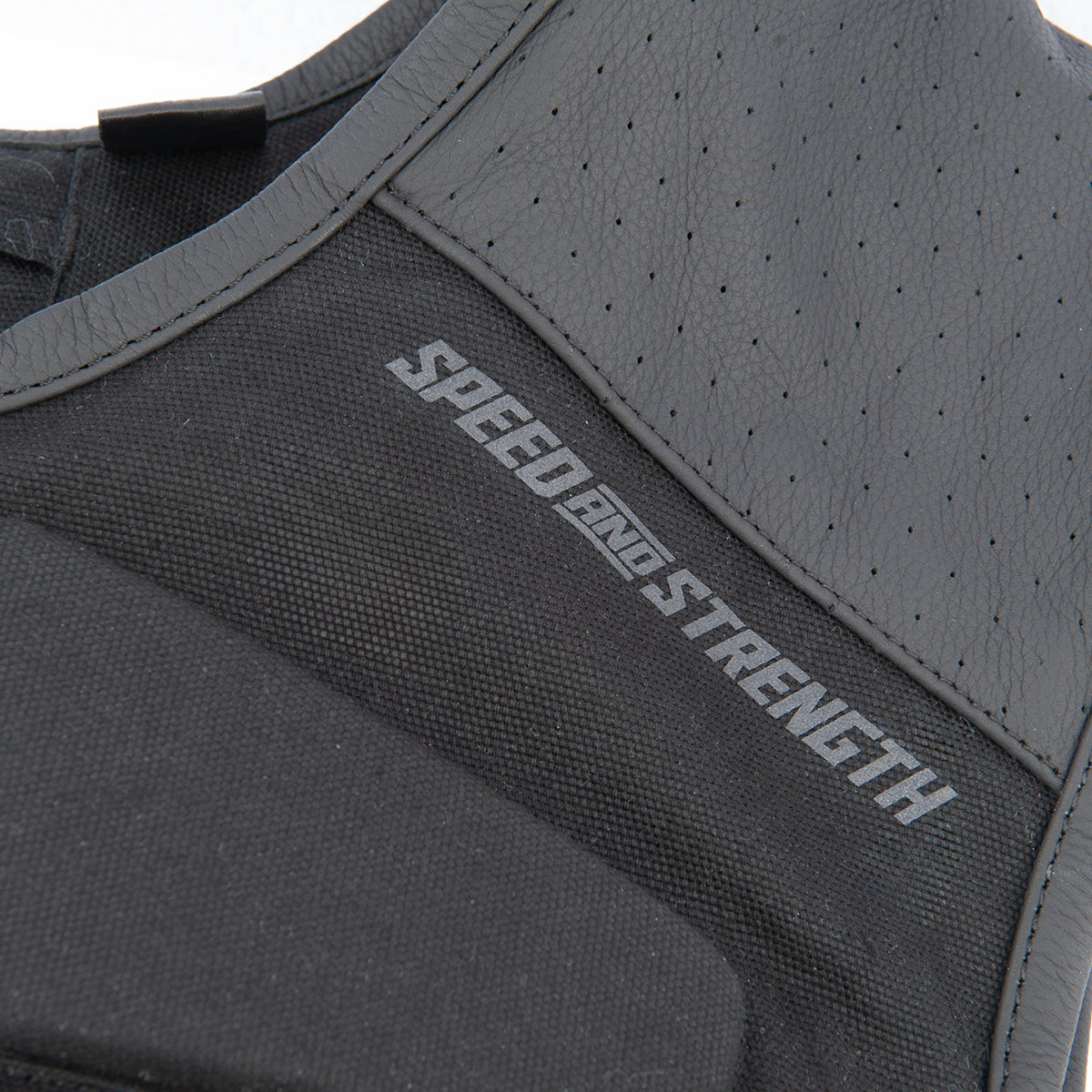 Black protective vest with 'Speed and Strength' branding on a white background